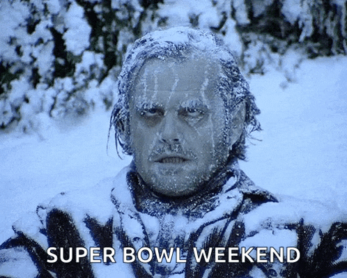 a man is covered in snow with the words super bowl weekend written below him