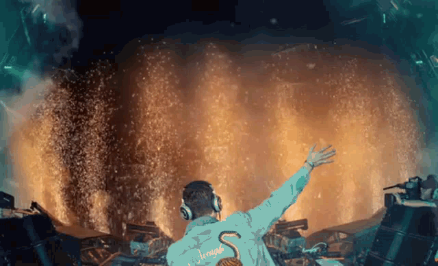 a man in a flamingo jacket is standing in front of a fire