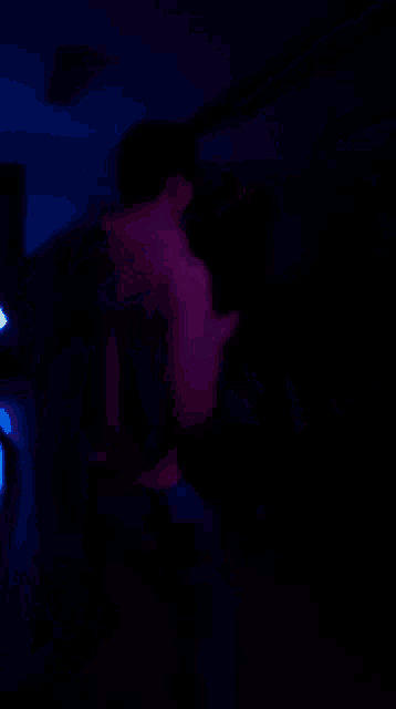 a blurry picture of a person dancing in a dark room