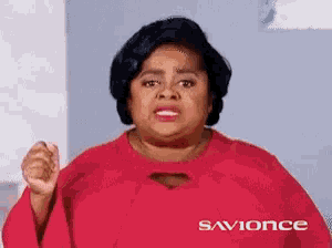 a woman wearing a red shirt that says savionce