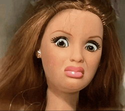 a close up of a doll making a face