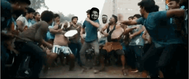 a group of people are dancing with a man in a blue shirt with the number 17 on his shorts