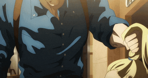 a man in a blue shirt is tying a woman 's hair in a ponytail