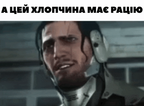 a man in a helmet is making a funny face .