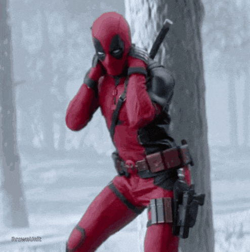 a man in a deadpool costume is standing in the snow