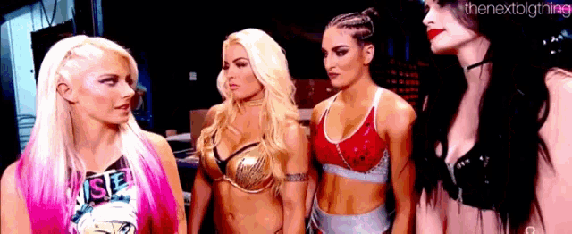 a group of women standing next to each other with one wearing a shirt that says ' rise '
