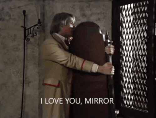 a man hugging a mirror that says " i love you mirror " on it