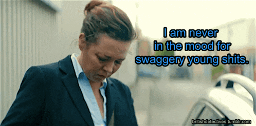 a woman in a suit is standing next to a car with the words i am never in the mood for swaggery young shits