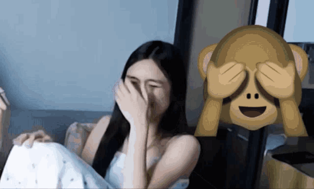 a woman covering her eyes next to a monkey covering his eyes