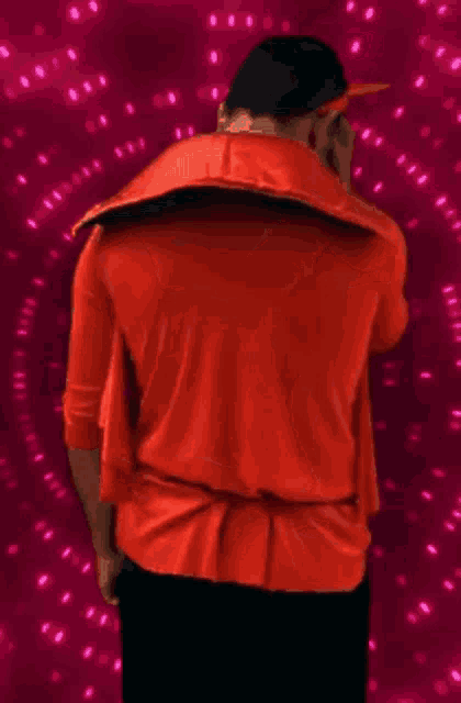 a man in a red hoodie is dancing with a pink arrow pointing to his butt