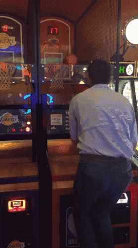 a man is playing a basketball game with a lakers logo on the screen