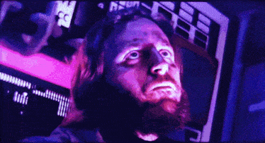 a close up of a man 's face with a purple background