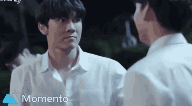 two men are standing next to each other and the word momento is on the bottom