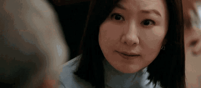 a close up of a woman 's face looking at a man .