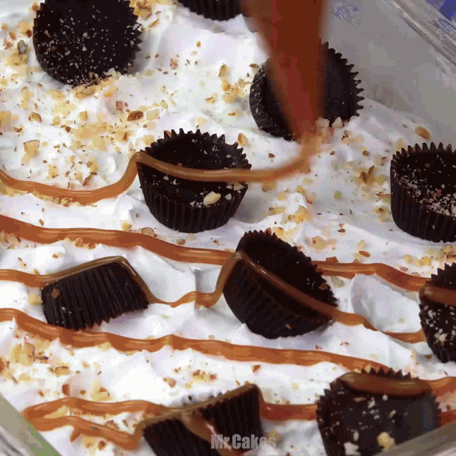a casserole dish filled with cupcakes and whipped cream with the words mrs. cakes written on the bottom