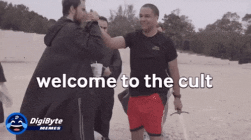 a group of men standing on a beach with the words welcome to the cult in the corner