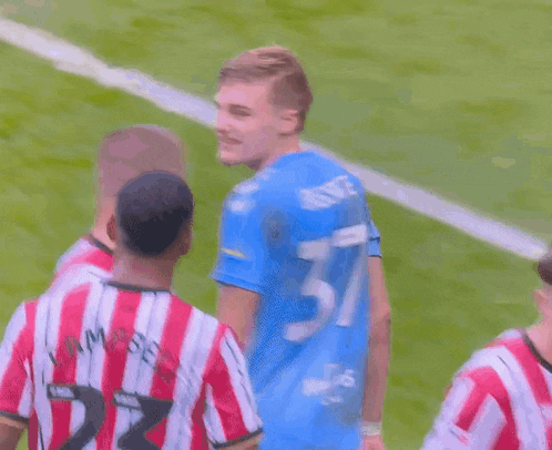 a soccer player wearing a blue shirt with the name bassite on it