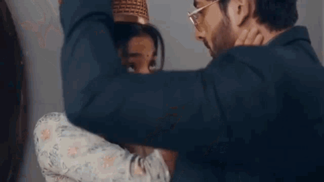 a close up of a woman touching a man 's face with her hand .
