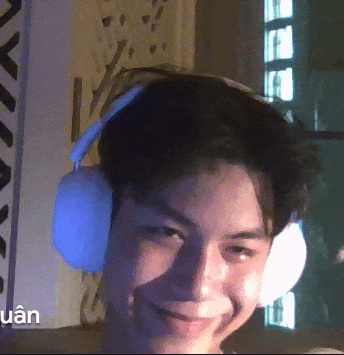 a man wearing headphones is smiling and the word quan is on the bottom
