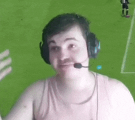 a man with a mustache is wearing headphones and a microphone while watching a soccer game .