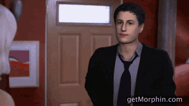 a man in a suit and tie stands in front of a door with the website getmorphin.com visible