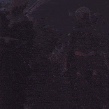 a woman with horns is standing next to a man with horns and a sword