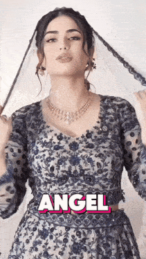 a woman with a veil on her head has the word angel written above her