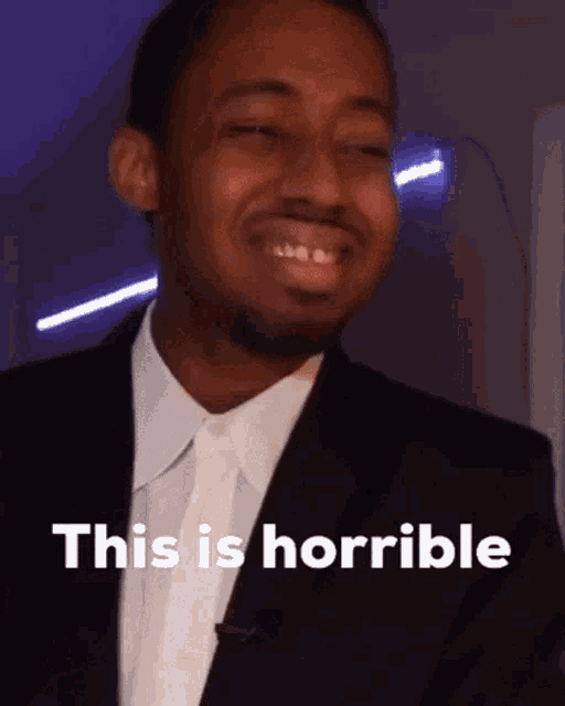 a man in a suit says " this is horrible " in front of him