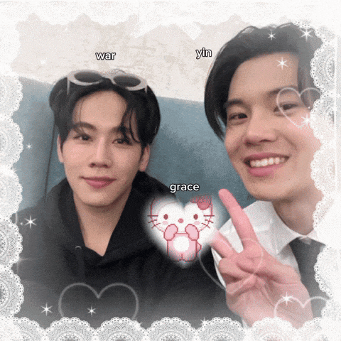 two men are posing for a picture and one of them has a hello kitty in his hand
