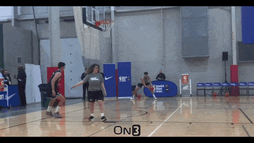 a basketball game is being played on a court that has an onb logo