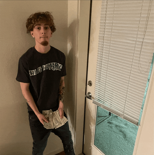 a young man wearing a black shirt that says ' wildflower '