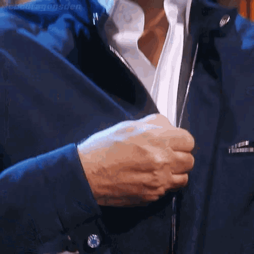 a close up of a person 's hands holding a jacket