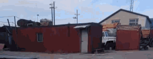a red building with a white truck in front of it