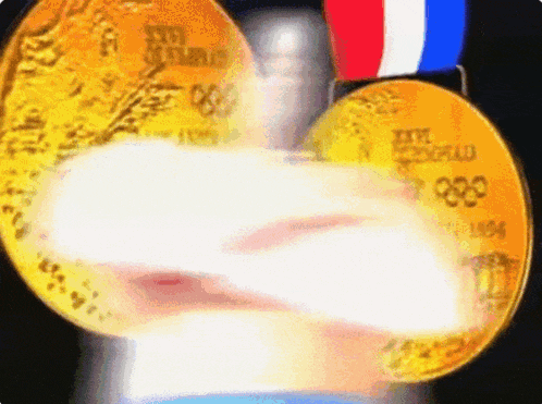 two gold medals from the 1984 olympics are being held together