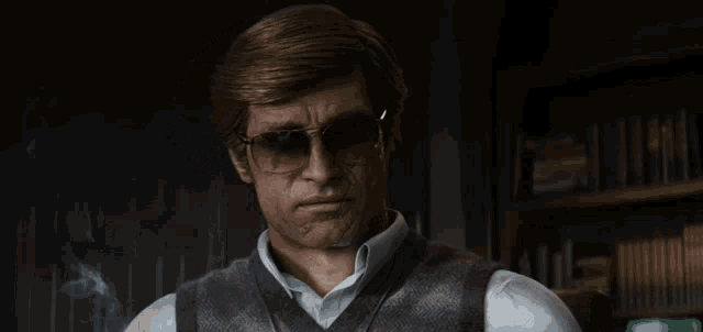 a man wearing sunglasses and a vest stands in front of a bookshelf