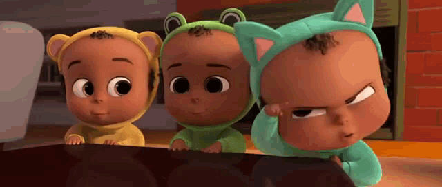 three cartoon babies wearing costumes are standing next to each other and looking at something .