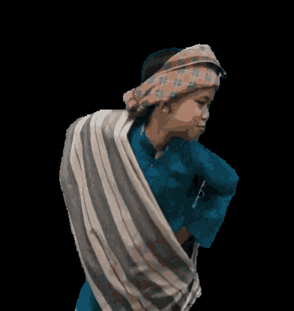 a person wearing a blue shirt and a plaid headband