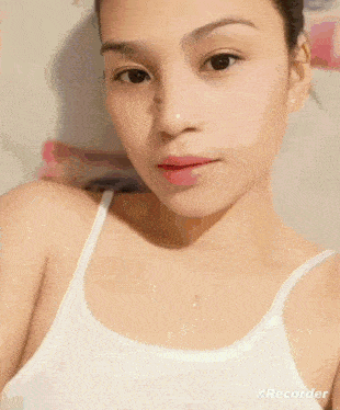 a woman wearing a white tank top with the word always written on it