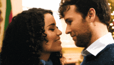 a man and a woman are looking at each other and smiling