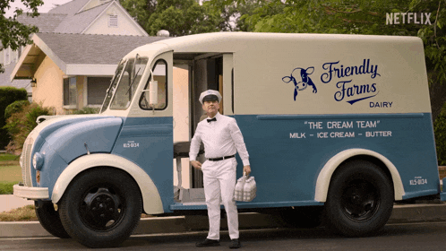 a friendly farms dairy truck with a man in front of it