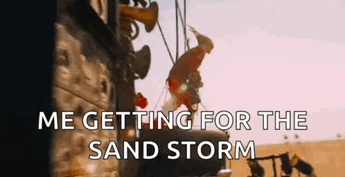 a person is getting ready for a sand storm in a desert .