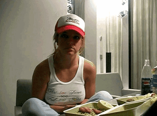 a woman wearing a white tank top that says first love lover