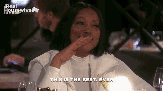 a woman says this is the best ever while covering her mouth with her hand