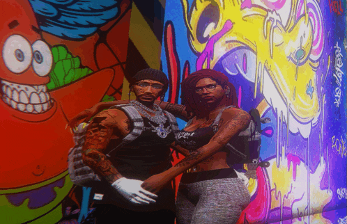 a man and a woman are posing in front of a colorful wall with a spongebob character on it