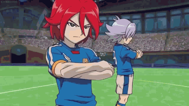 two anime characters are standing on a soccer field with their arms crossed