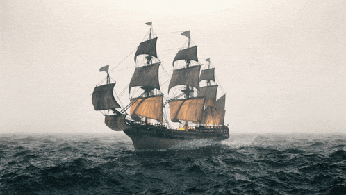 a large sailboat is floating in the middle of a large body of water