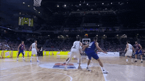 a basketball game is being played in a stadium with a few ads for coca-cola
