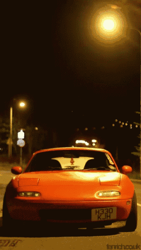 a red sports car with a license plate that says h330 kjh