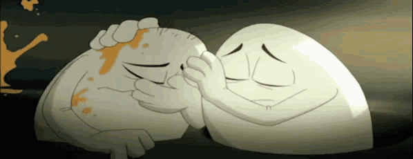 two cartoon eggs are hugging each other and one has blood on it