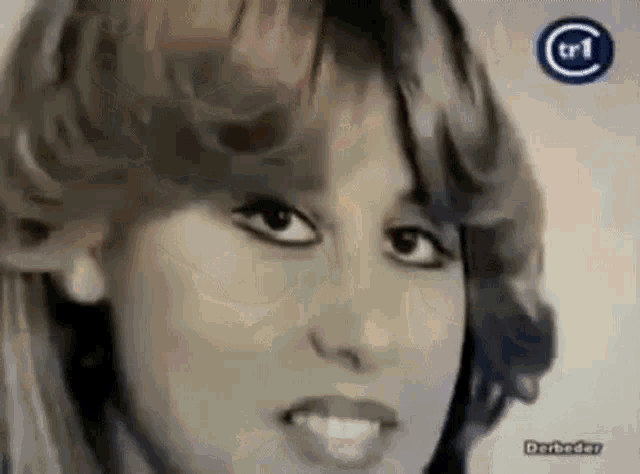 a black and white photo of a woman 's face with a tr1 logo on the bottom .
